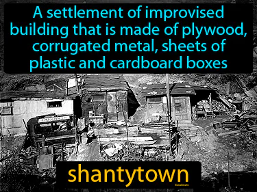 a settlement made of plywood, metal, plastic and cardboard boxes